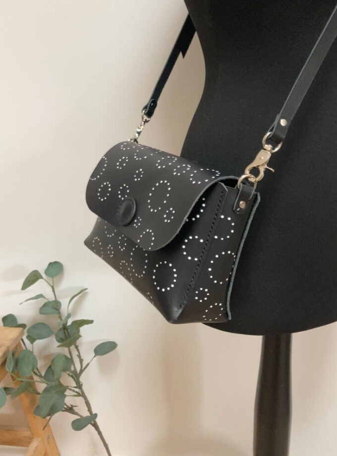handmade-black-leather-cross-body-bag-silver-hardware-hand-painted-circle-spots-plain-leather-strap-side-view-closeup
